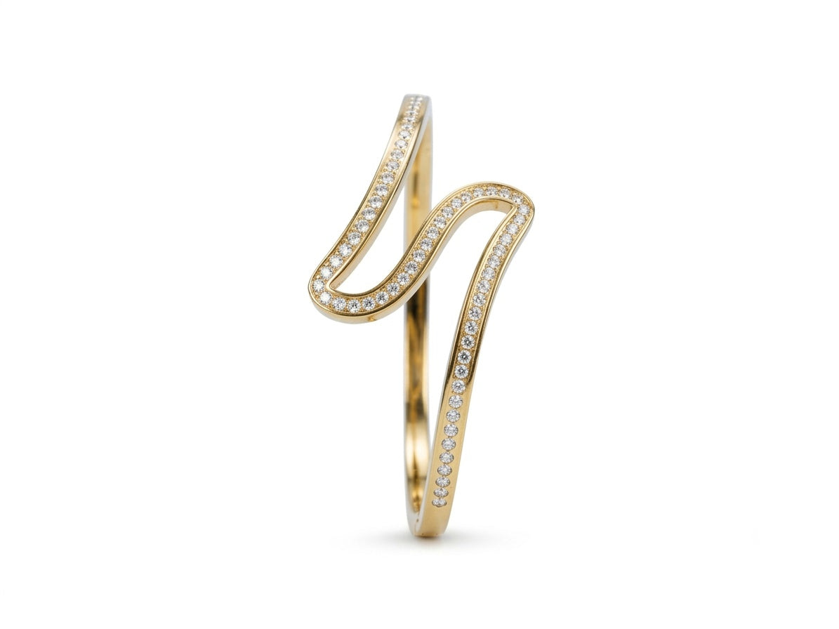 A gold S-shaped wrap ring adorned with pavé-set clear stones on a clean white background.