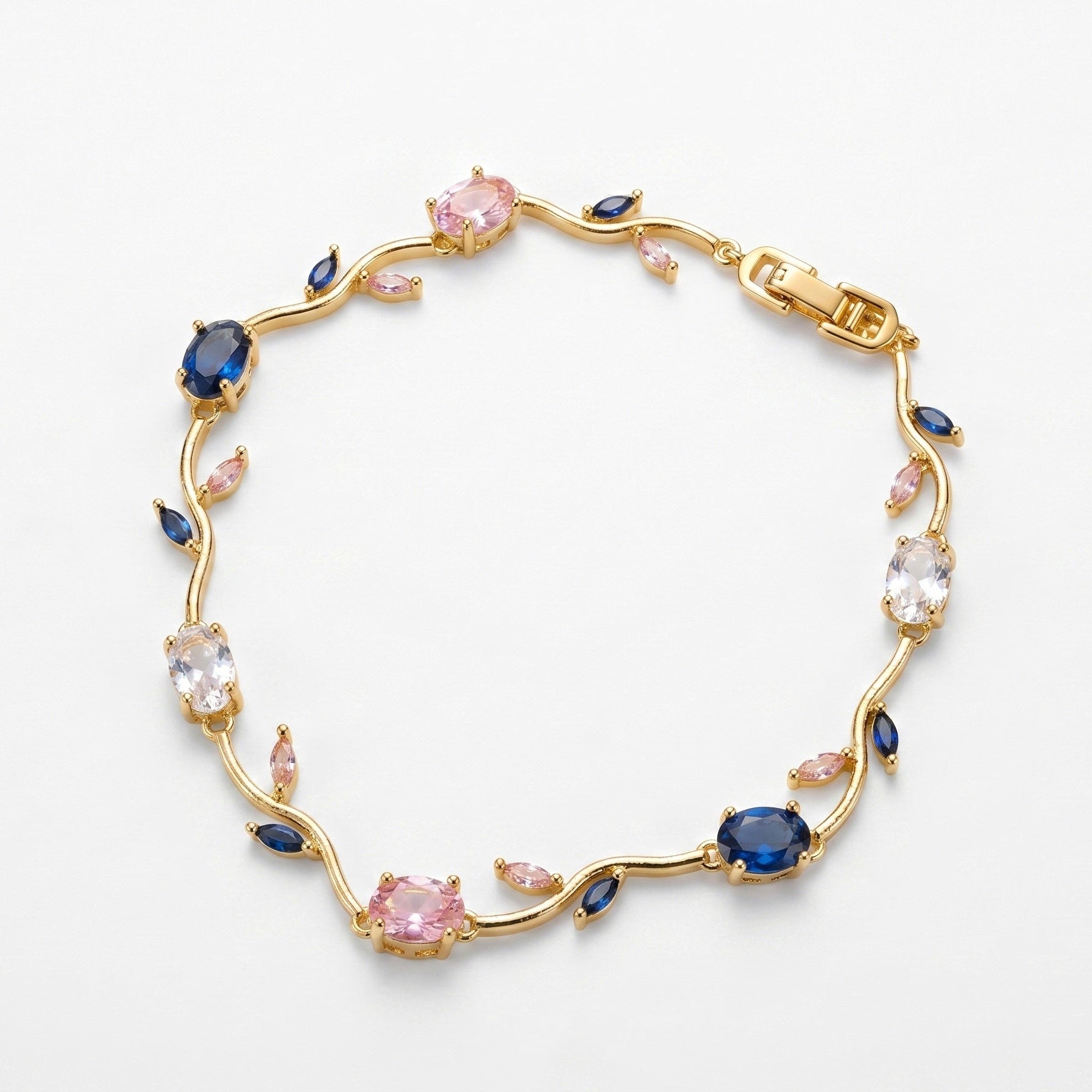 A gold vine-style bracelet featuring round pink and oval blue gemstones, clear round stones, and small marquise-cut pink accents, displayed on a clean white background.