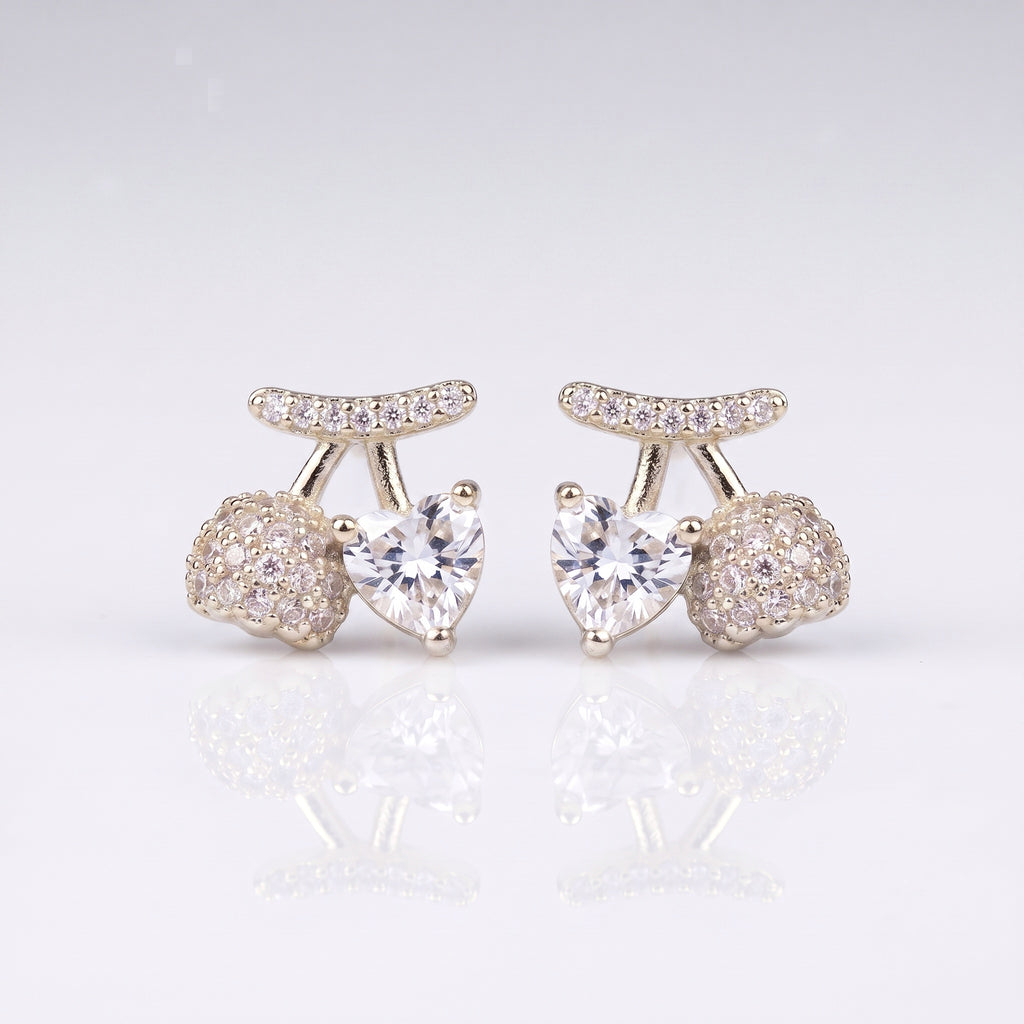 A pair of silver-toned stud earrings featuring a central heart-shaped clear gemstone, flanked by round pavé-set clear stones and a curved pavé top bar, 