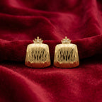 A pair of gold clutch-style earrings with a crown-shaped top and a vertically ribbed, textured body