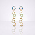 A pair of gold-tone dangle earrings with circular enamel details in blue, pale green, and white