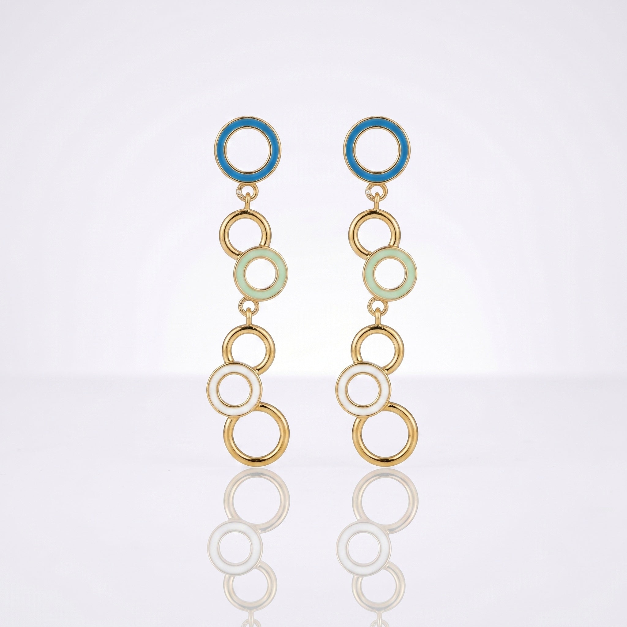 A pair of gold-tone dangle earrings with circular enamel details in blue, pale green, and white