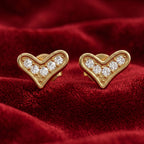 Gold heart-shaped earrings with embedded diamonds