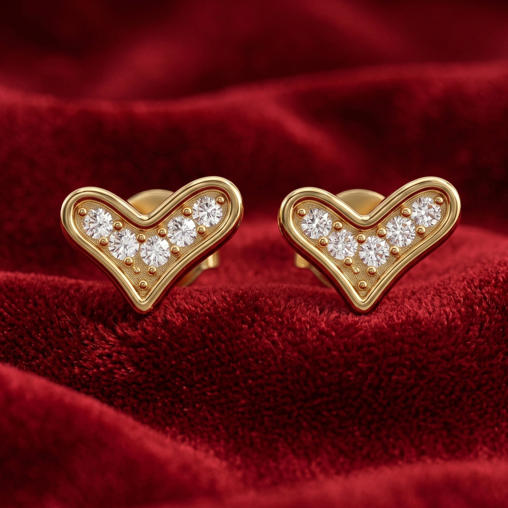 Gold heart-shaped earrings with embedded diamonds