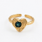 Gold heart-shaped ring with a green gemstone