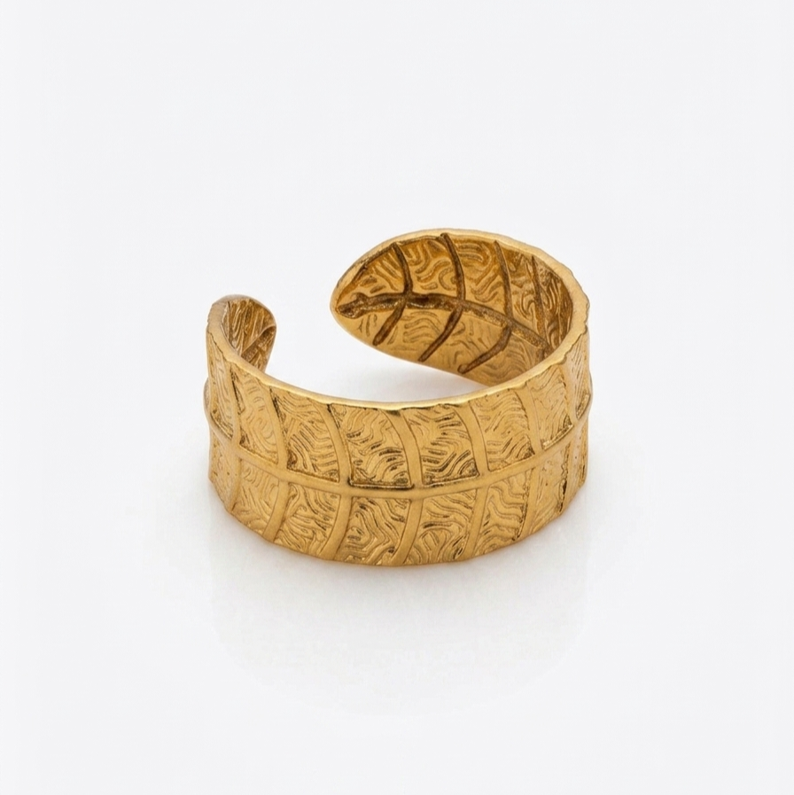 Gold leaf pattern ring on a white background