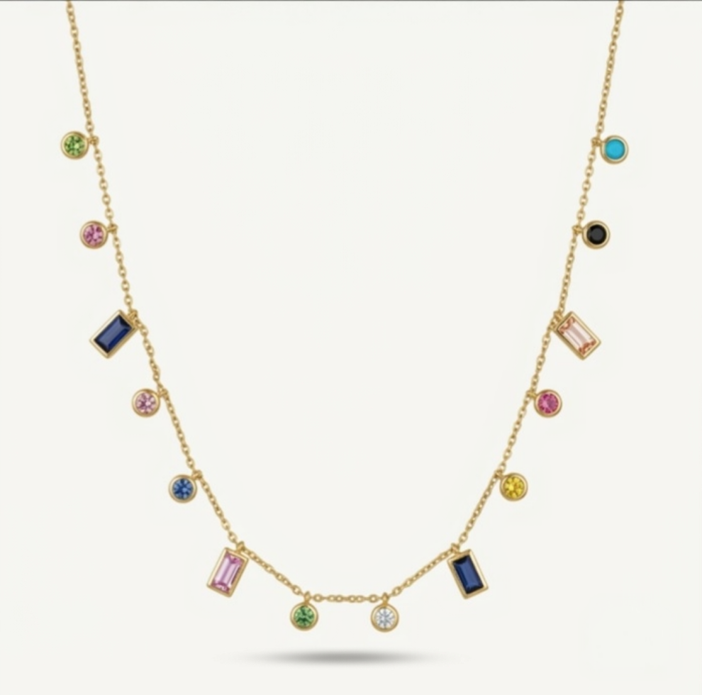 A gold chain necklace featuring multiple colorful gemstone charms in various shapes, including round, oval, and rectangular settings, displayed against a light off-white background.