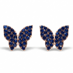 A pair of butterfly-shaped stud earrings set with deep blue gemstones in a rose gold-tone metal, displayed on a clean white background.