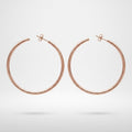 A pair of minimalist, thin hoop earrings in a polished rose gold finish, displayed against a clean white background with a soft shadow underneath.