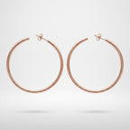A pair of minimalist, thin hoop earrings in a polished rose gold finish, displayed against a clean white background with a soft shadow underneath.