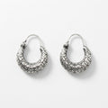 A pair of textured silver crescent hoop earrings with a raised, patterned surface and fishhook backings, displayed on a clean white background.