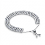 A silver-toned triple-row diamond bracelet with a beaded extender chain and ball clasp, displayed on a clean white background.