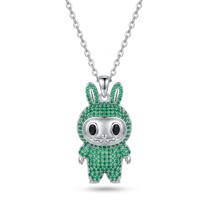 A silver pendant necklace featuring a cartoon bunny character encrusted with green stones, suspended from a silver chain against a white background.