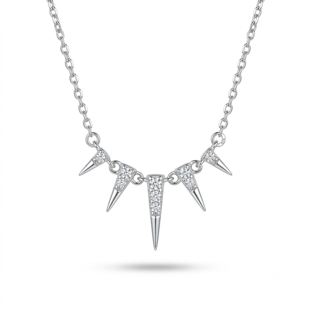 A silver-toned spike necklace featuring three pointed spikes on a delicate link chain, with the center spike adorned with small clear stones, shown against a plain white background.