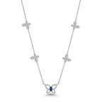 A silver-toned necklace featuring five diamond-paved butterfly motifs along the chain, with a larger butterfly pendant at the center set with a round blue gemstone, shown on a plain white background.