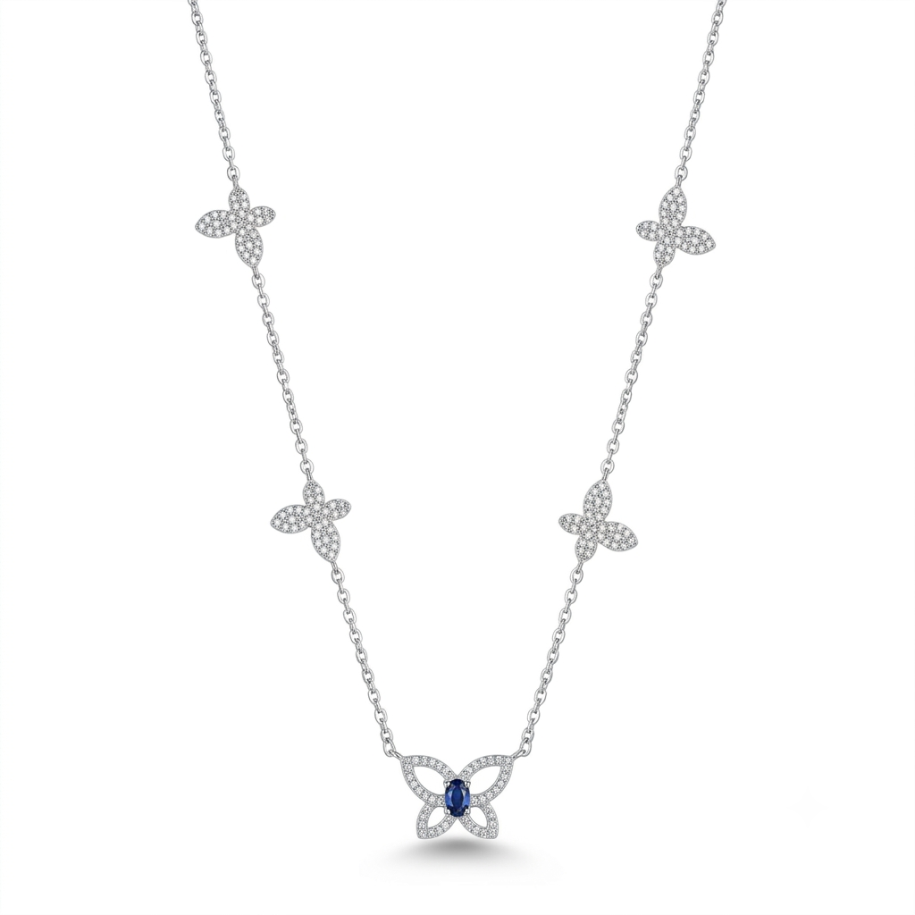 A silver-toned necklace featuring five diamond-paved butterfly motifs along the chain, with a larger butterfly pendant at the center set with a round blue gemstone, shown on a plain white background.