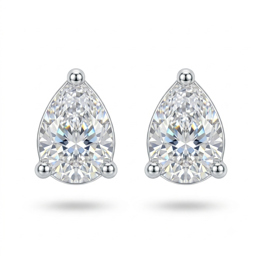 A pair of pear-cut diamond stud earrings in a three-prong silver setting, displayed on a clean white background with soft drop shadows.