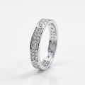 A silver-toned eternity ring featuring rows of small clear pavé stones with three larger round-cut center stones, photographed on a clean white background.