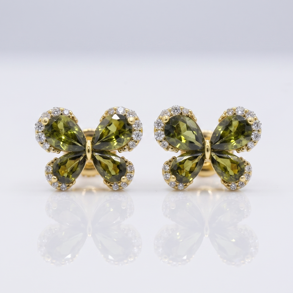 Pair of green butterfly-shaped earrings with gold accents on a white background