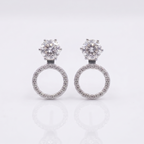 Pair of silver earrings with circular designs on a light gray background