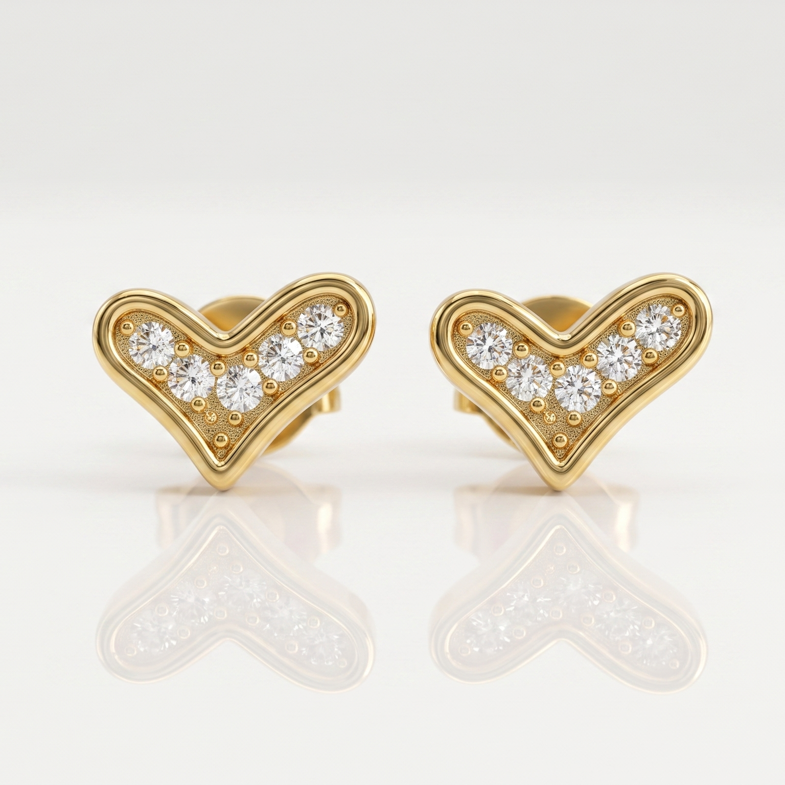 Gold heart-shaped earrings with embedded diamonds
