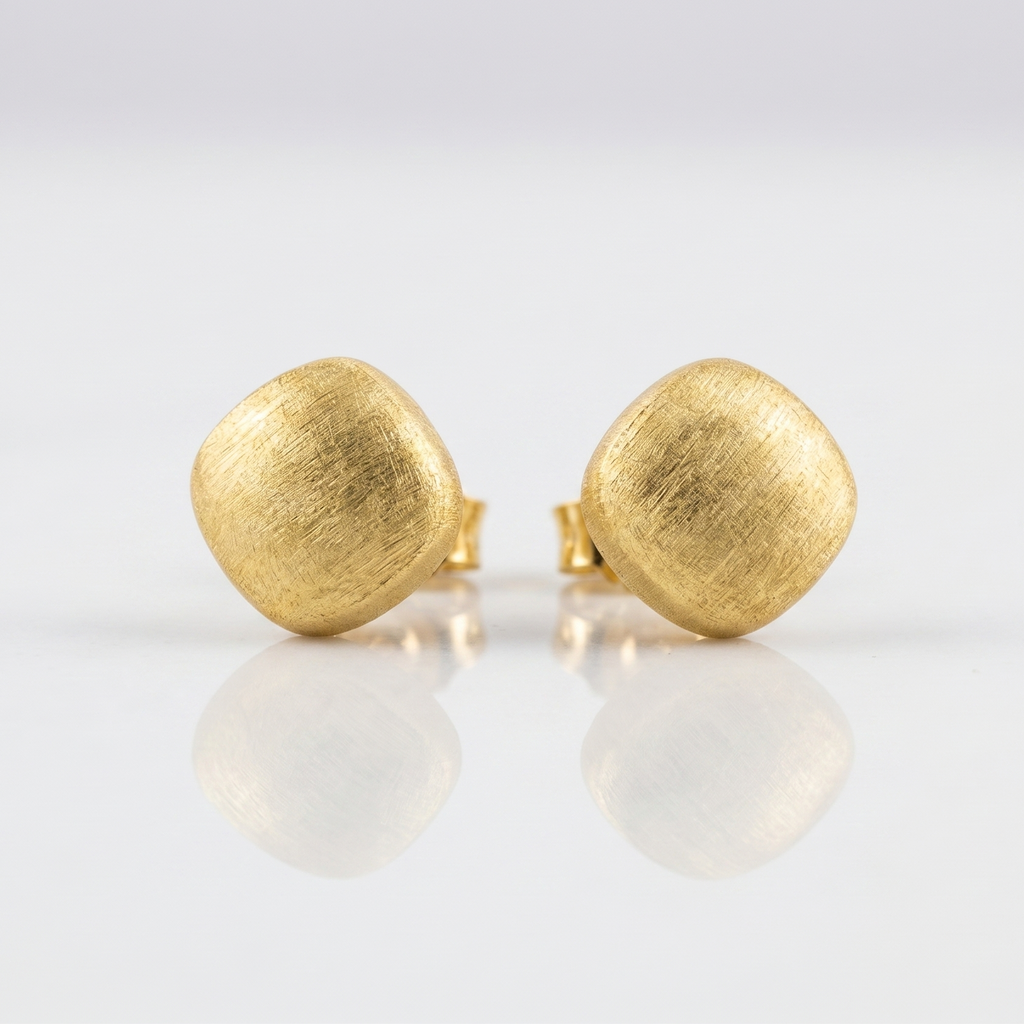 Pair of gold earrings on a white background