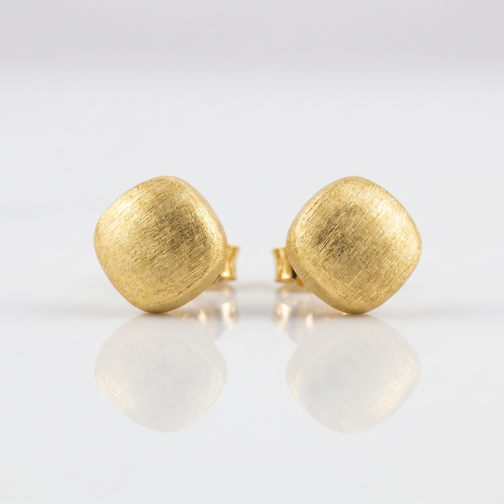 Pair of gold earrings on a white background