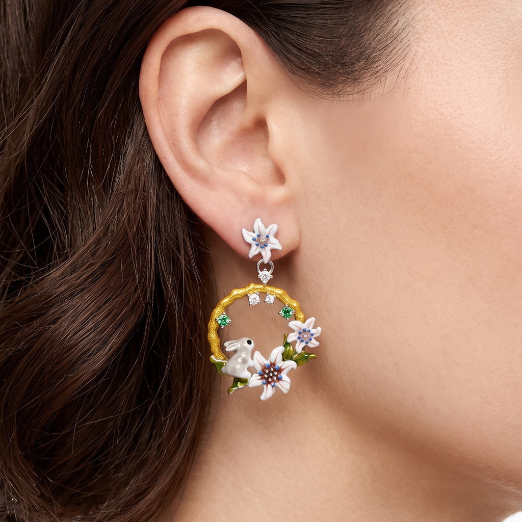 Close-up of a person wearing floral hoop earrings with a blurred background