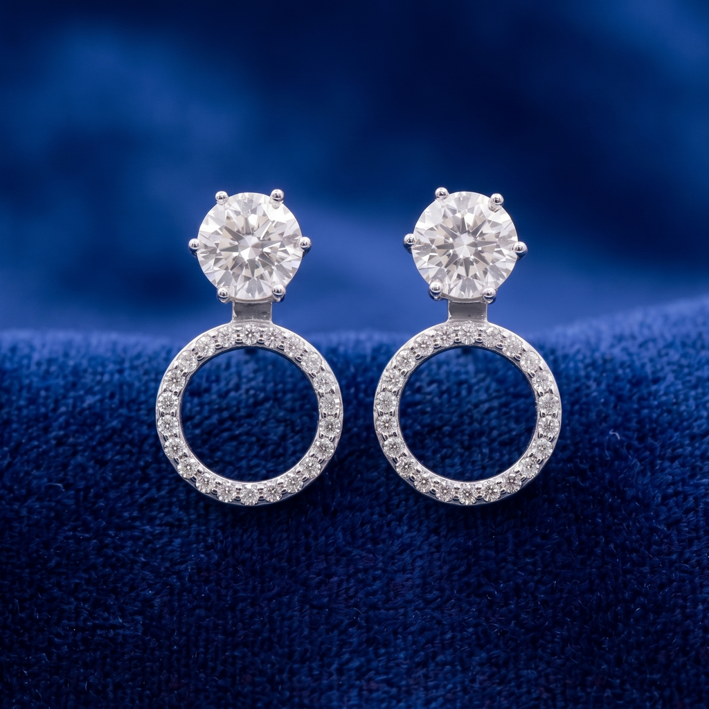 Pair of diamond earrings on a blue textured background