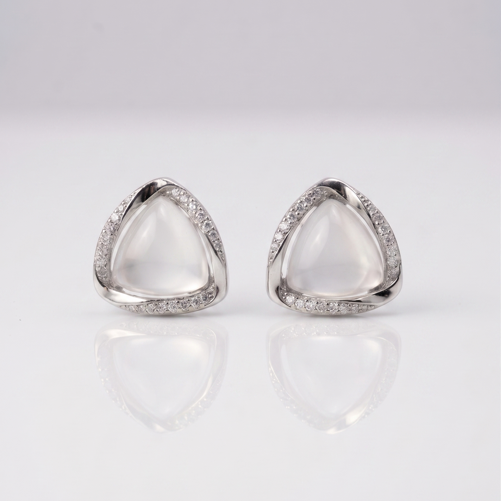 Pair of silver triangle earrings on a light gray background