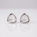 Pair of silver triangle earrings on a light gray background