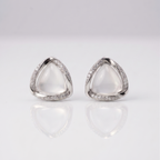 Pair of silver triangle earrings on a light gray background