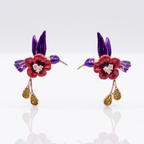 Pair of floral earrings with red flowers, purple leaves, and gold accents on a white background