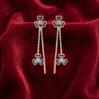 earrings with purple clover-shaped stones with diamonds and gold drop