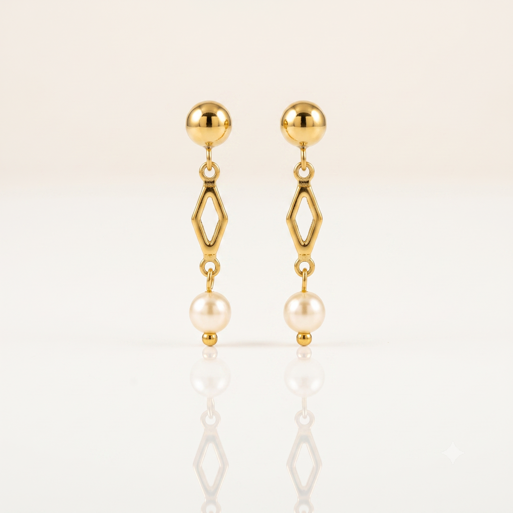 A pair of gold dangle earrings with a spherical stud, an open diamond-shaped link, and a hanging pearl, displayed on a clean white reflective surface.