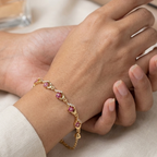 Gold bracelet with pink gemstones and crystals