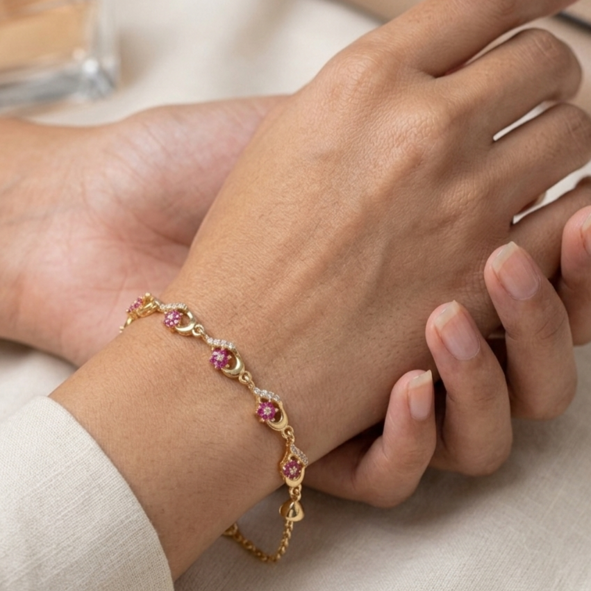 Gold bracelet with pink gemstones and crystals
