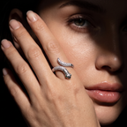 silver snake-shaped ring on her finger 