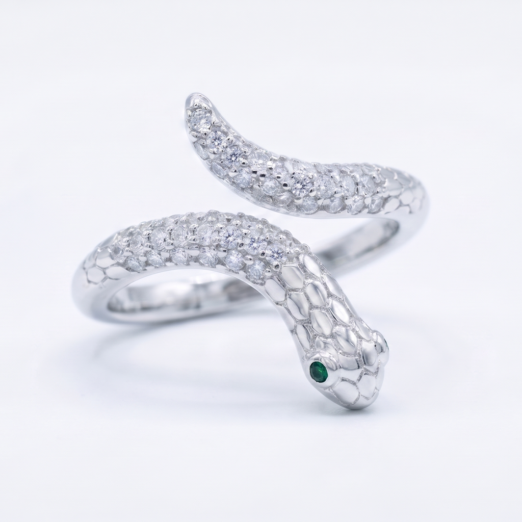 Silver snake-shaped ring with a green gemstone and diamonds