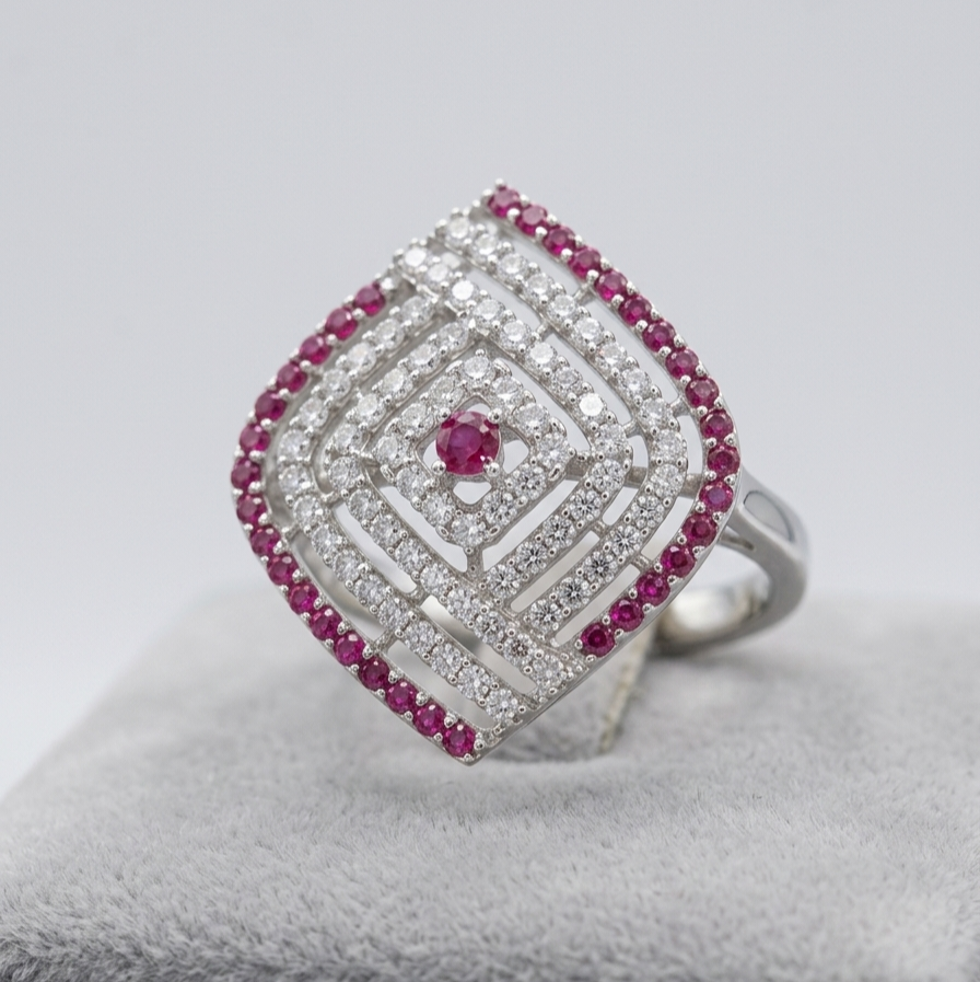 Silver ring with red gemstones and diamonds