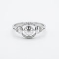 Silver ring with intricate design on a white background