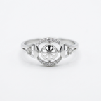 Silver ring with intricate design on a white background