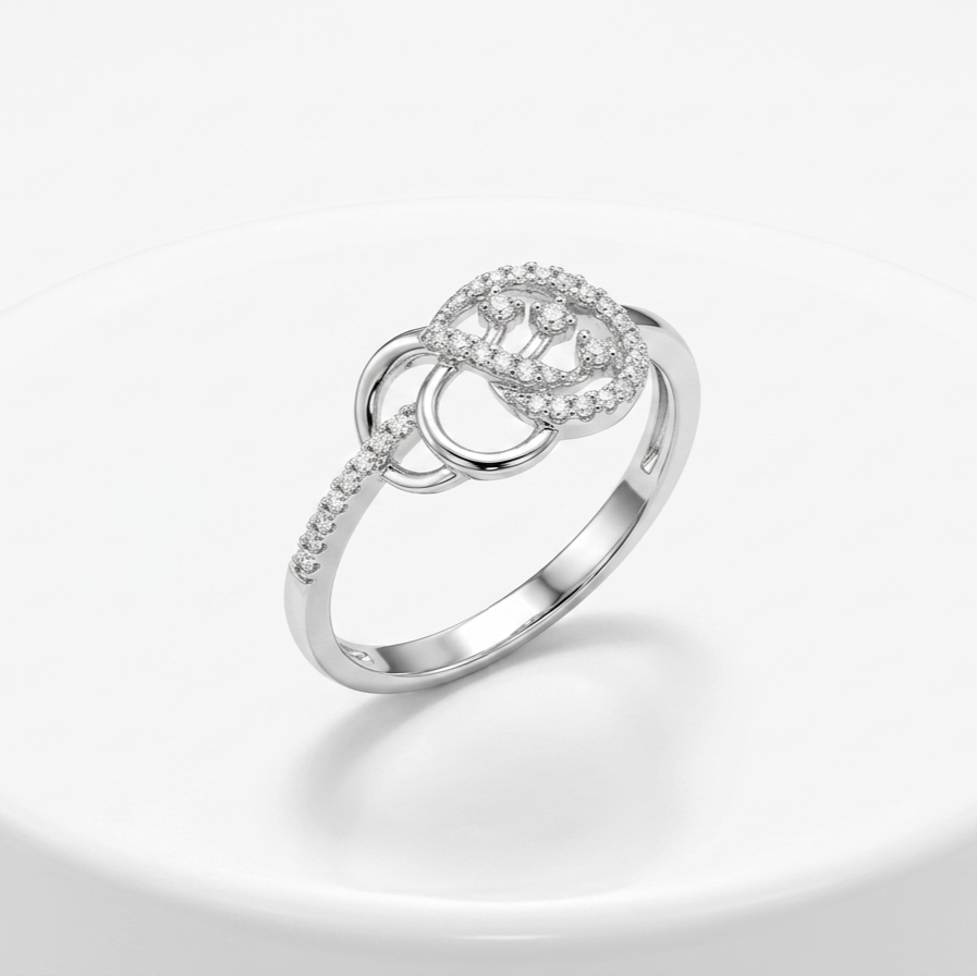 Silver ring with diamond accents on a light gray background