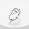 Silver ring with diamond accents on a light gray background