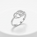 Silver ring with diamond accents on a light gray background