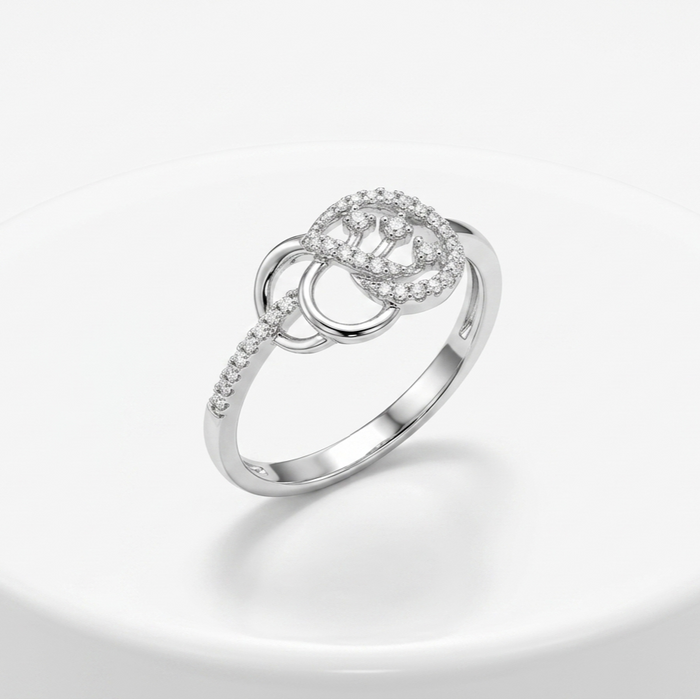 Silver ring with diamond accents on a light gray background