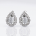 Pair of silver earrings with large gemstones on a white background
