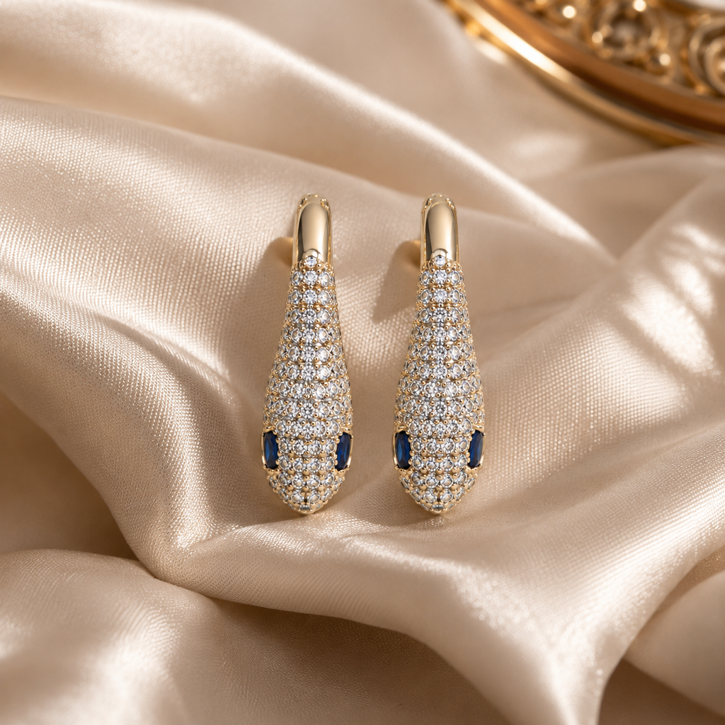 snake rose gold earrings with diamonds and blue stone eyes