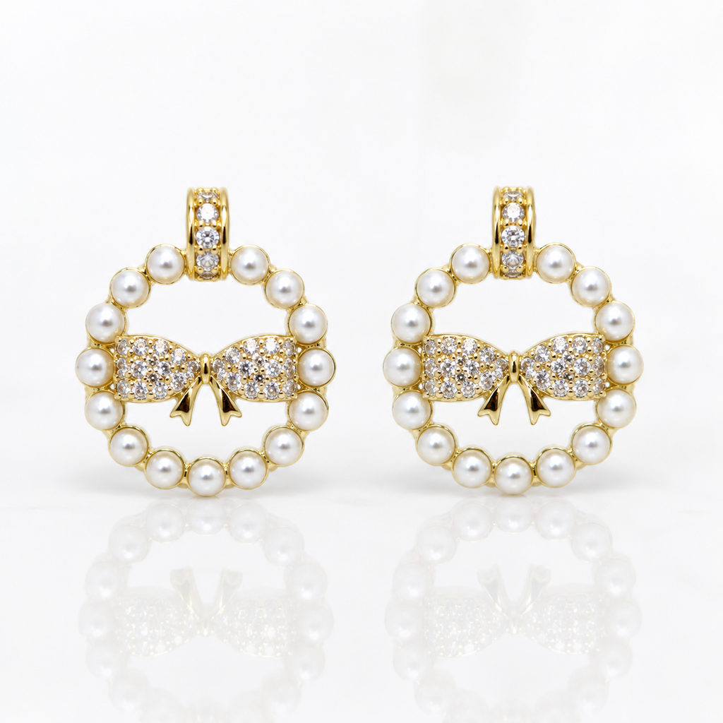 Pair of earrings with pearl and bow design
