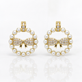 Pair of earrings with pearl and bow design